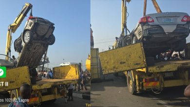 Photo of Heavily loaded container falls on Toyota car in Lagos, driver miraculously cheats death 